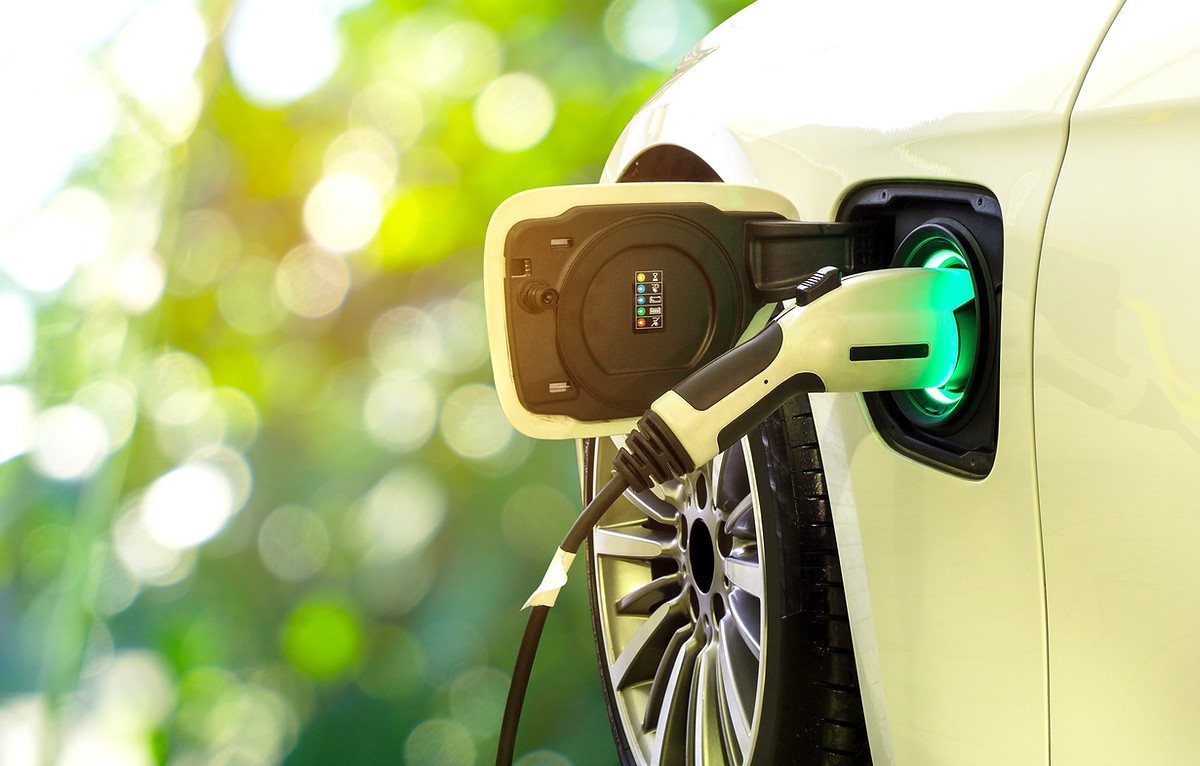 Electric vehicle home charger plugged into a vehicle